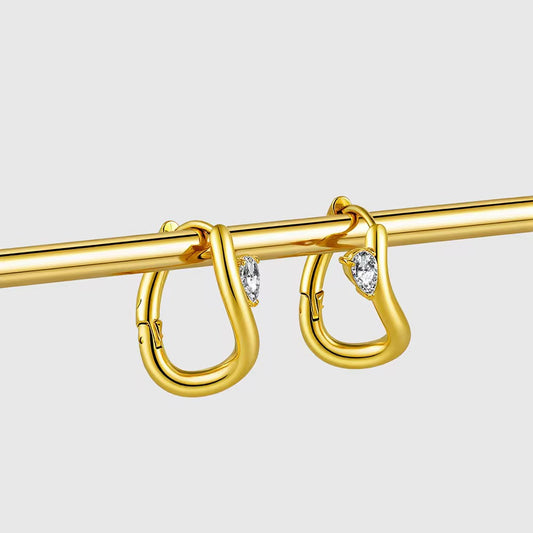 Abstract gold earring with gem