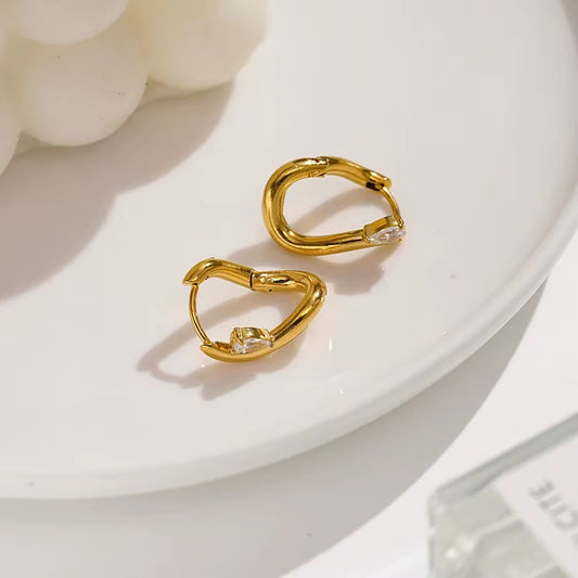 Abstract gold earring with gem